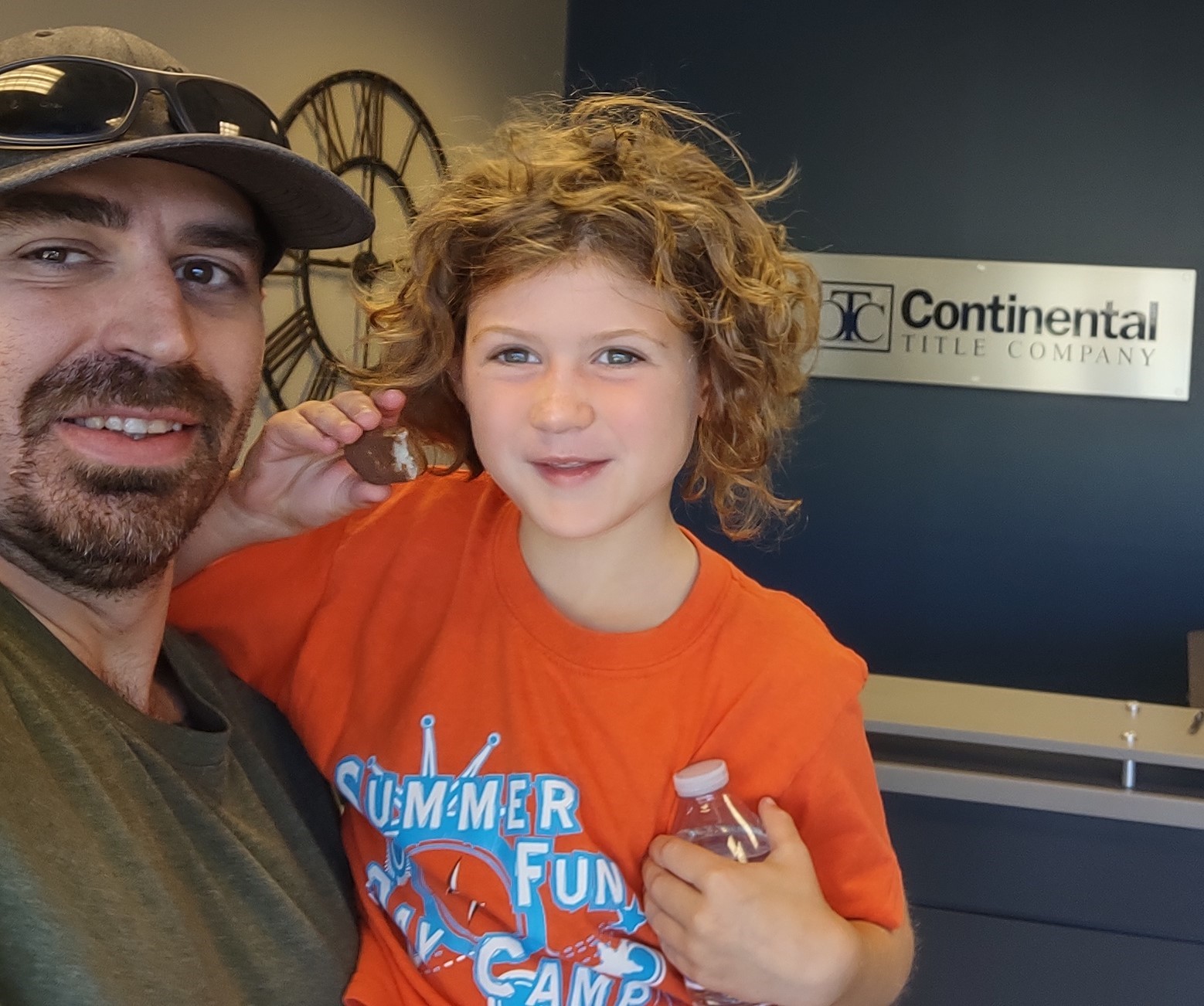 House buyer holding daughter at a closing at Continental Title